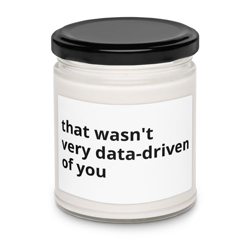 Soy candle in a glass jar with label reading that wasn't very data-driven of you, front view