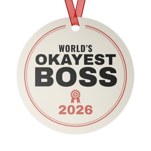 World's Okayest Boss 2026 Christmas ornament, front: cream round metal ornament reading WORLD'S OKAYEST BOSS 2026 with a red award ribbon icon, red ribbon